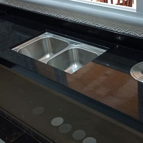 Detalhe da cuba dupla de inox embutida em granito preto